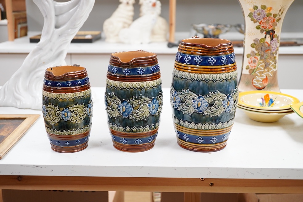 A graduated set of three Doulton Lambeth stoneware jugs, signed. Condition - good